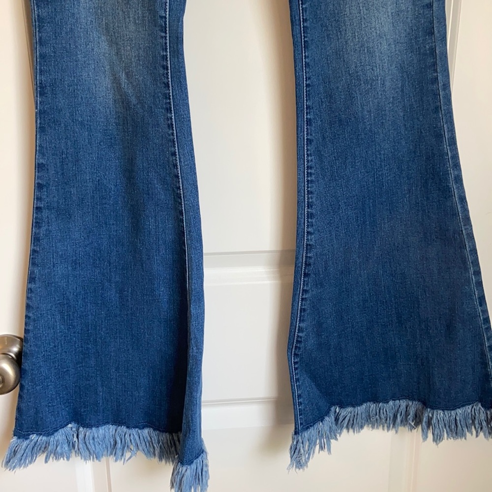 Brand new bell bottom jeans with button front. 31” inseam.